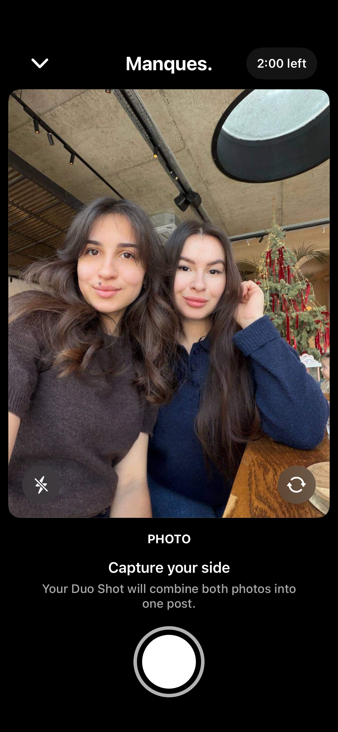 Two friends taking a duo shot in a cafe